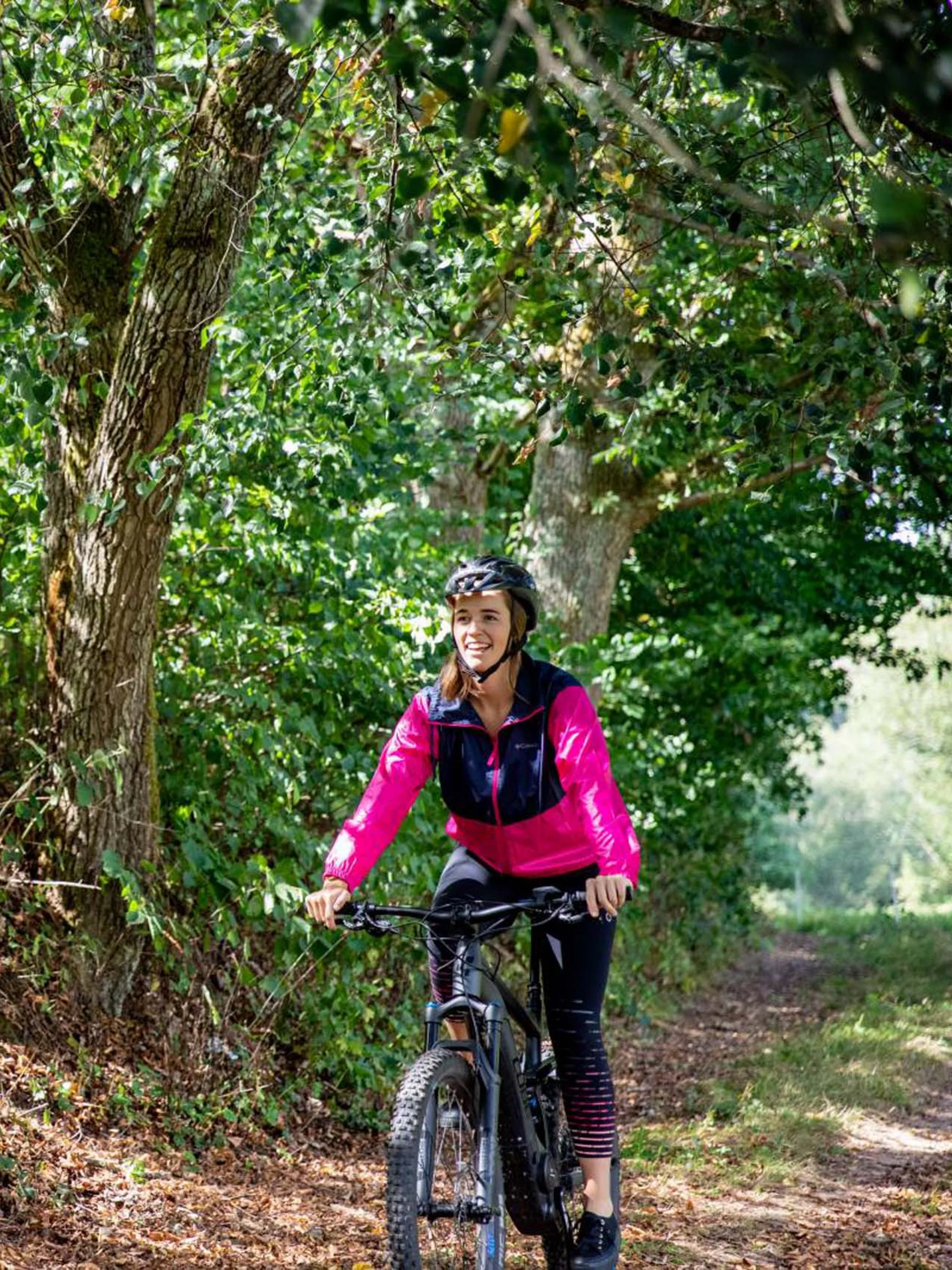 Pfalzblick: your nature hotel in Rhineland-Palatinate Woman riding mountain bike on forest trail under green trees