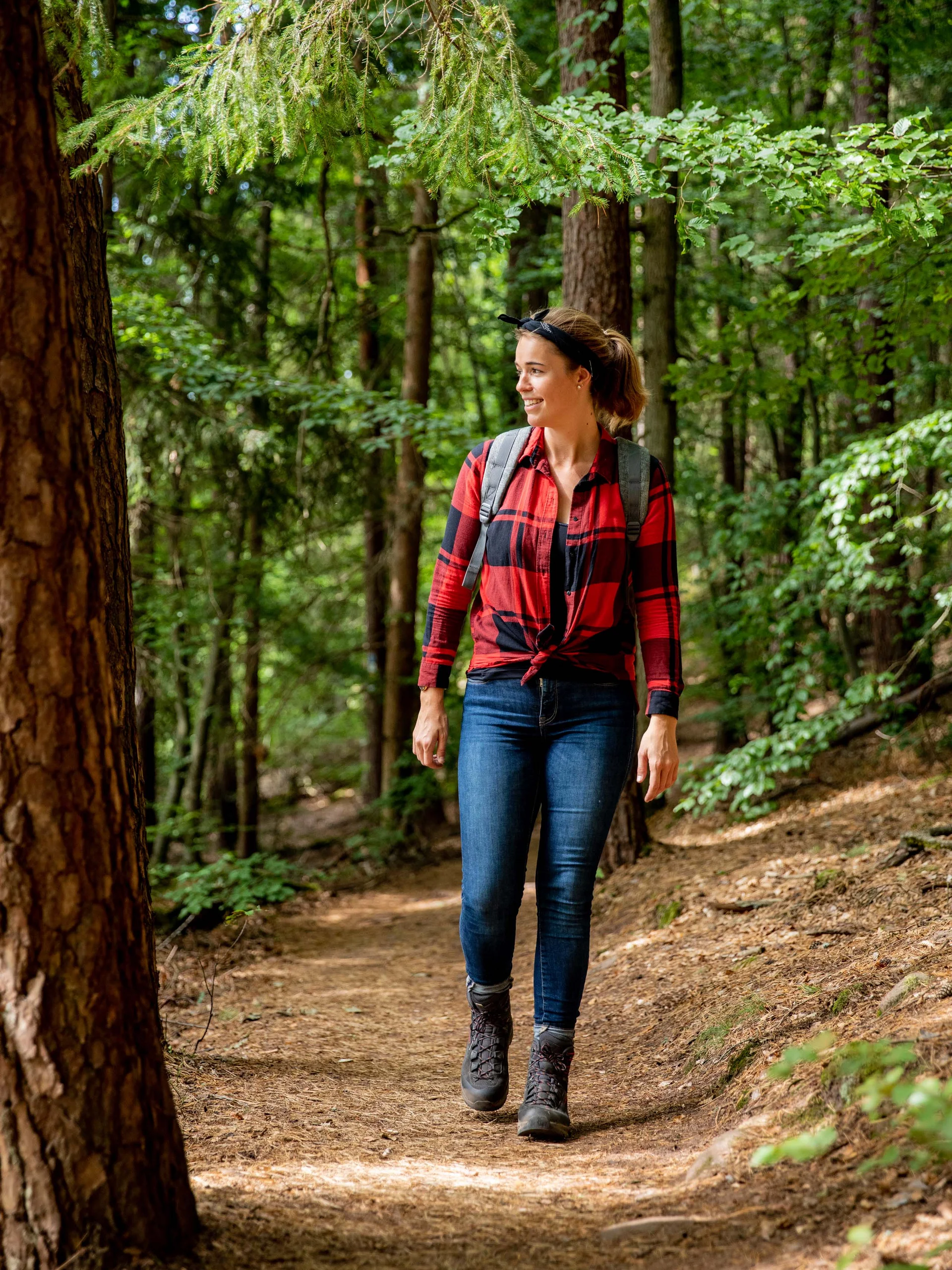 Pfalzblick: your nature hotel in Rhineland-Palatinate Woman hiking on forest trail wearing red shirt and backpack